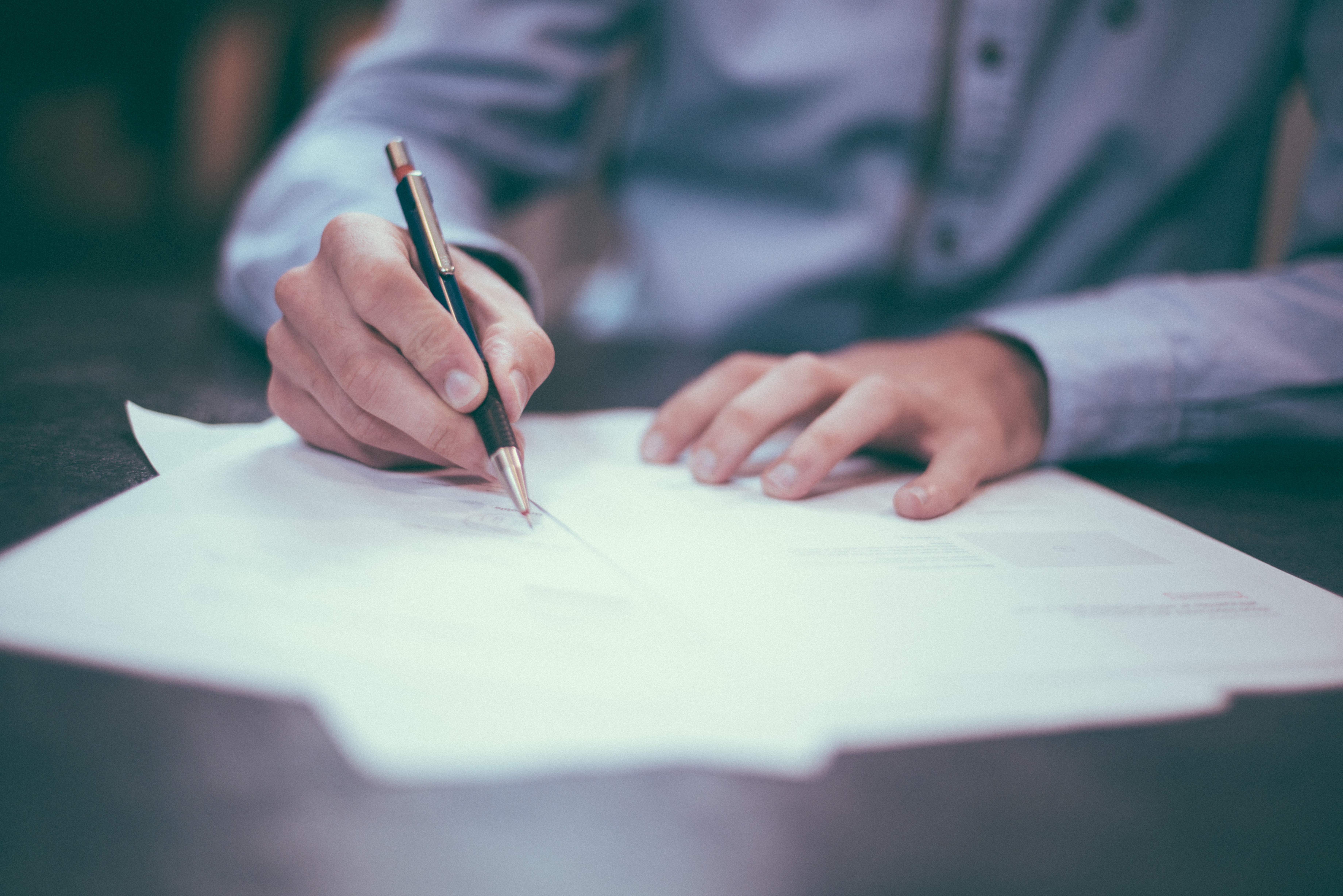 Man signing law document
